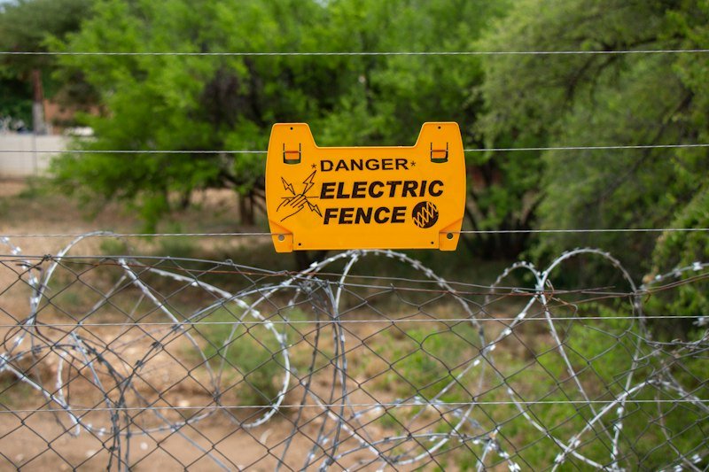 Electric fence with danger warning sign